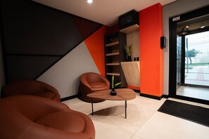 A modern interior with a sofa, a small table, and a plant.
