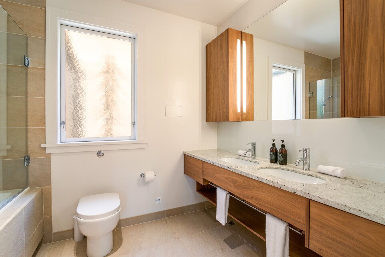 A bathroom with a toilet, sink, and shower.