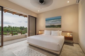 A hotel room with a large bed, a view of palm trees, and a painting on the wall.