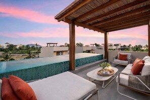 A rooftop terrace with a swimming pool, lounge chairs, and a covered seating area. - Stylish 4BR Beach Casita (Zihuatanejo)