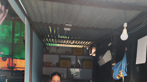 A compact room with a desk, shelves, and a refrigerator. - Anand Home Stay (Kathmandu)
