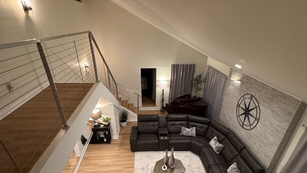 A modern living room with a sectional sofa, two armchairs, a coffee table, and a staircase leading to an upper level. - Beautiful Masters Rental, 3 Miles from Augusta National Golf Course (Augusta)