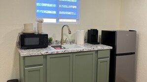 A kitchen with a sink, microwave, refrigerator, and a window with blinds. - Cozy 1-bedroom completely private guest house in Fresno with refreshing AC (Fresno)