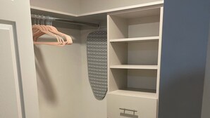 A walk-in closet with hanging space, shelves, and drawers. - Luxury Prime Brickell Condo, Pool, Gym, Free Parking (Miami)
