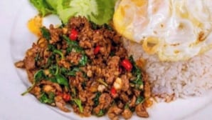 A plate with stir-fried meat, rice, and a fried egg. - Sovanphum Riverside Hotel (Phnom Penh)