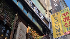 A multi-story building with a sign for 'BELIN STAY' indicating a hotel. - Belin Stay Myeongdong & Jongno (Seoul)