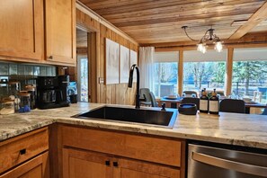 Private kitchen - Sunny Retreat River Cabin -Fishing/HotTub/Sauna/EV (Concrete)