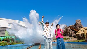 A water feature with a large fountain, a building with a distinctive design, and a rocky landscape in the background. - Mauve Glamor Chengdu (Chengdu)