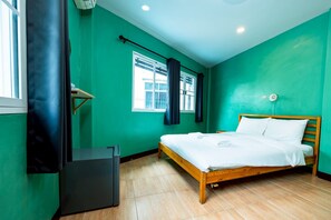 A room with a bed, a desk, and a window with curtains. - GO INN The Giant Swing (Bangkok)