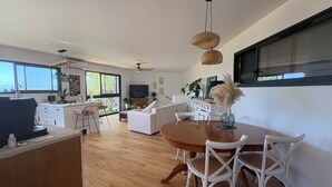 A modern kitchen with a dining area, white furniture, and a large window. - 🌿 Charming house with jacuzzi & open view - Haven of peace 🌞 (Bastelicaccia)