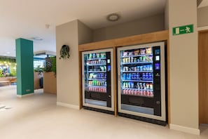 Two self-service beverage vending machines in a modern indoor setting. - Travelodge Bilbao Sestao (Sestao)