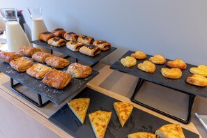 A buffet with various pastries and a glass of milk. - Travelodge Bilbao Sestao (Sestao)