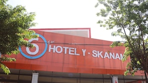 A building with a prominent sign reading 'HOTEL Y-SKANAM.' - Edu Hotel Y-skanam (Surabaya)