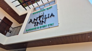 A hotel sign with the name 'ANTILIA INN' and the tagline 'Elegance in every stay.' - Antilia Inn (Badami)