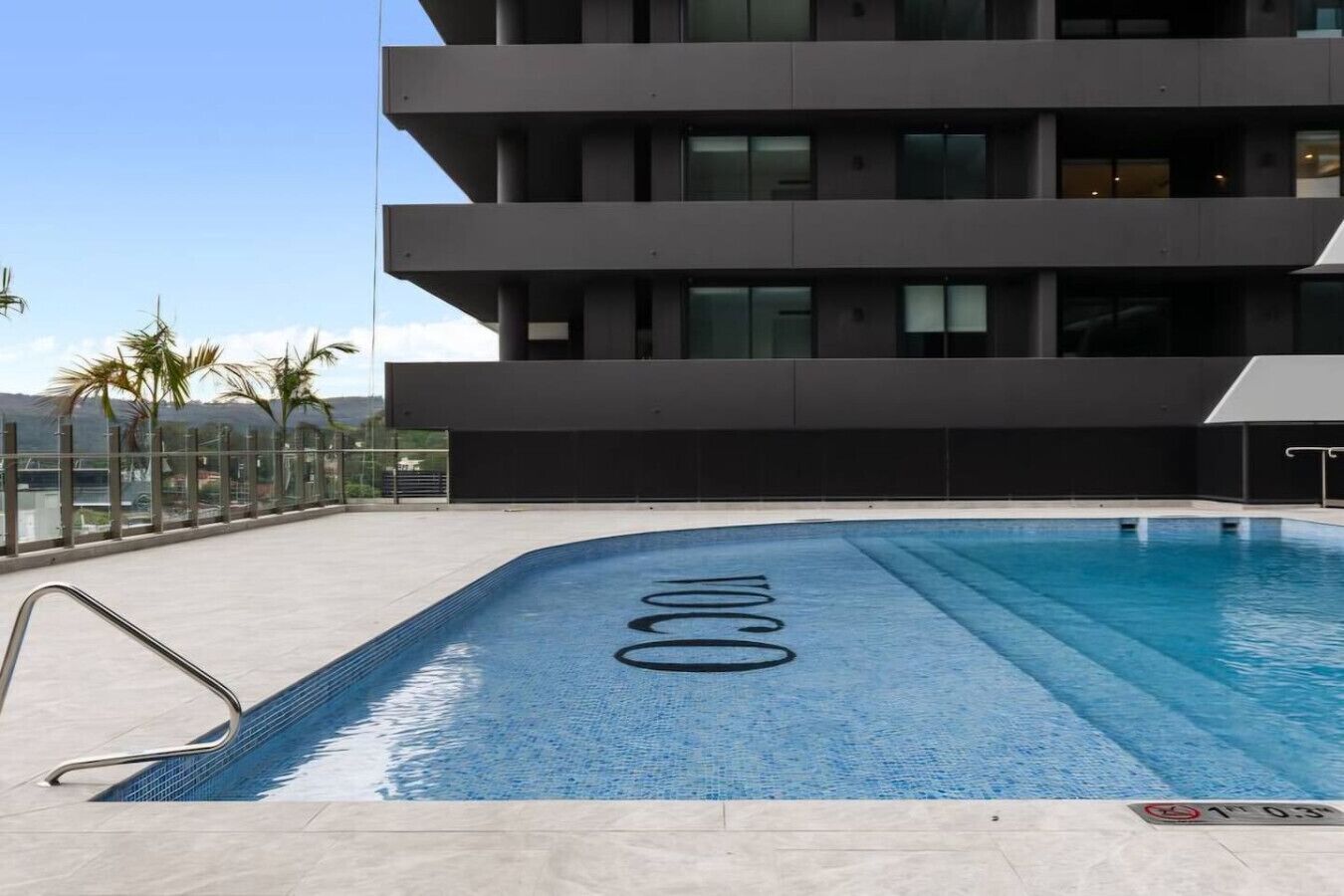 A modern building with a rooftop pool.