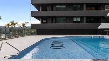 A modern building with a rooftop pool.