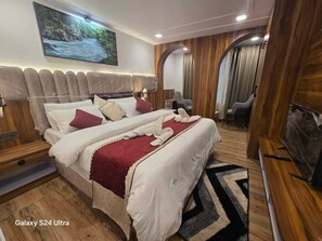 A Galaxy S24 Ultra room with a bed, wooden paneling, a TV, and a painting on the wall.
