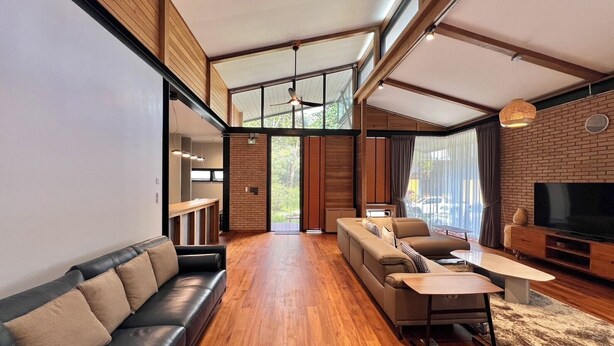 A modern living room with a sofa, a coffee table, and a TV. - La Wong Creek at Pang Hi (Doi Saket)