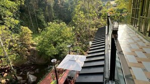 A staircase leading to a balcony with a view of a forested area and a small stream. - La Wong Creek at Pang Hi (Doi Saket)