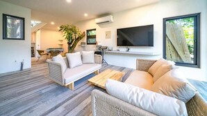 A modern living room with a sofa, a coffee table, and a TV. - sun on the cloud (Shoufeng)