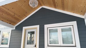 A house with a dark gray exterior, a white door with a glass panel, and a white-framed window with blinds. - Indy Michigan rd house in northwest of Indianapolis near 465 north, 4brds 3 bath (Indianapolis)