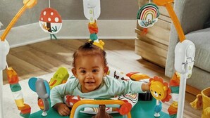A baby in a play gym with various toys attached to the sides. - Indy Michigan rd house in northwest of Indianapolis near 465 north, 4brds 3 bath (Indianapolis)