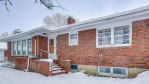 A brick house with a front porch, a chimney, and a window with a view of the sky. - 2 Mi to Downtown Billings! Charming Family Home (Billings)
