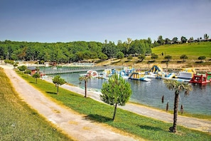 A riverside park with a walking path, boats, and water slides. - Cottage with Heated Pool in Monclar (Monclar-de-Quercy)