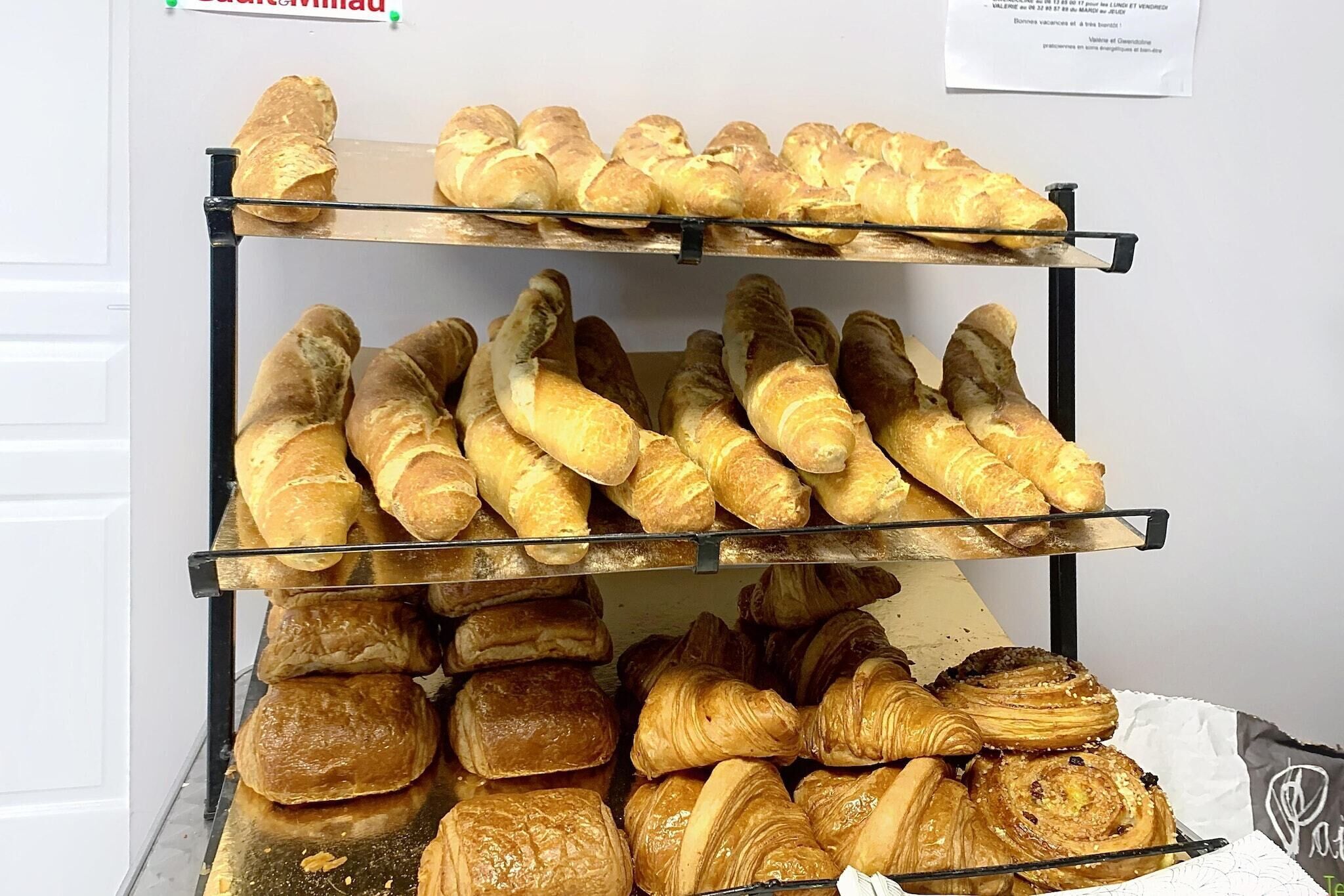 A display of various baked goods on a metal rack.