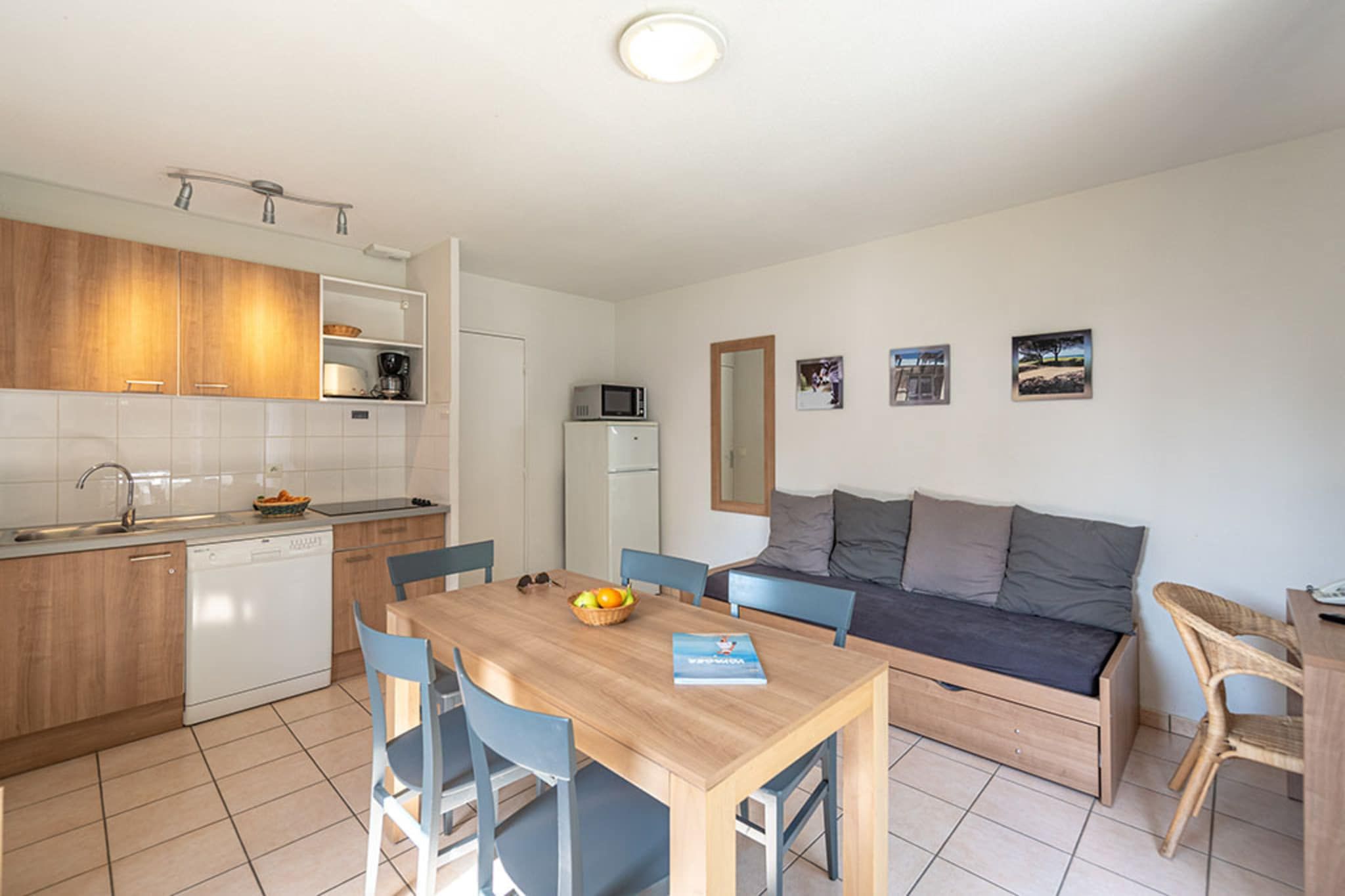A compact living space with a kitchenette, dining area, and seating area.