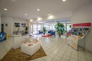 A spacious lobby with a reception desk, seating area, and informational displays. - 5-Guest Cottage with Terrace in Loire (Saumur)