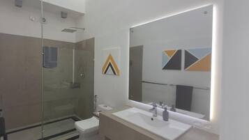 Deluxe Suite, Sea View, Beachfront | Bathroom | Shower, hair dryer, towels, soap