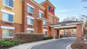 A hotel with a brick facade, multiple windows, and a clear sky. - Studio 6 Vernon Hills|ADA Queen bed,RI Shower,Nsmk|Kitchen (Chicago)