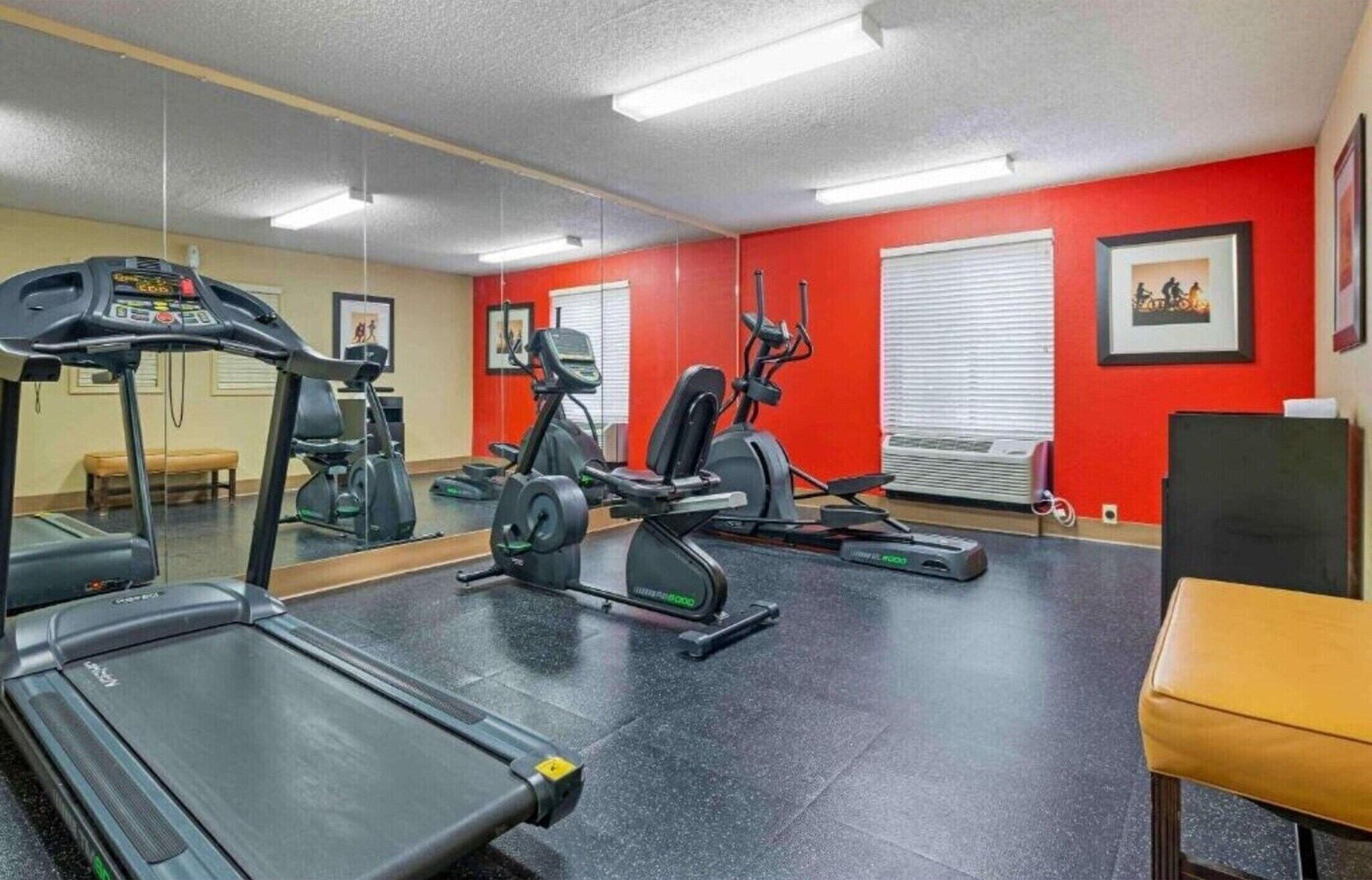A gym with a treadmill, elliptical, and stationary bike.