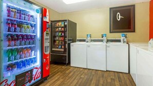 A room with a Coca-Cola vending machine, a self-service snack dispenser, and a row of washing machines. - 2 Queen Beds |Non-Smoking, Kitchen (Germantown)