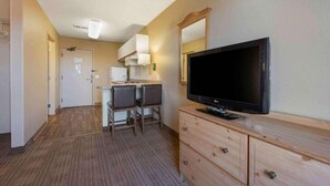 A hotel room with a television, a desk, a chair, a dresser, and a mirror. - 2 Queen Beds |Non- Smoking, Kitchen (Minneapolis MN)