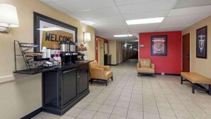 A hotel lobby with a reception desk, a 'WELCOME' sign, a coffee station, and seating areas. - 2 Full Beds | Non-Smoking, Kitchen (Rochester NY)