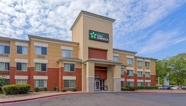 A multi-story hotel with a prominent 'Extended Stay America' sign, a lobby entrance, and a parking lot.