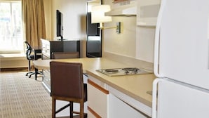 A compact hotel room with a kitchenette, a dining area, a TV, and a large window with curtains. - 2 Queen Beds | Smoking, Kitchen (Milwaukee WI)