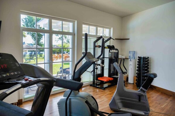 A gym with treadmills, a weight machine, and a water dispenser.