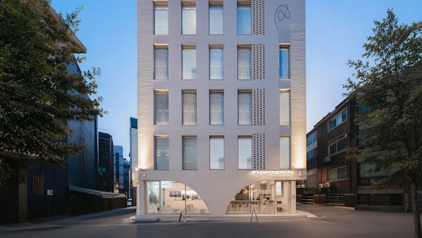 A modern building with a flat facade, multiple windows, and a sign for 'AL GANGHAM LOUNGE & SPA'. - Hotel at gangnam seoul (Seoul)
