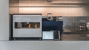 A modern coffee machine and a menu board in a commercial setting. - Hotel at gangnam seoul (Seoul)