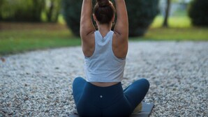 A person performing a yoga pose on a mat outdoors. - Spacious 6-bedroom house in  Varennes, pool, 3 outdoor spaces, full gym, bikes. (Varennes)