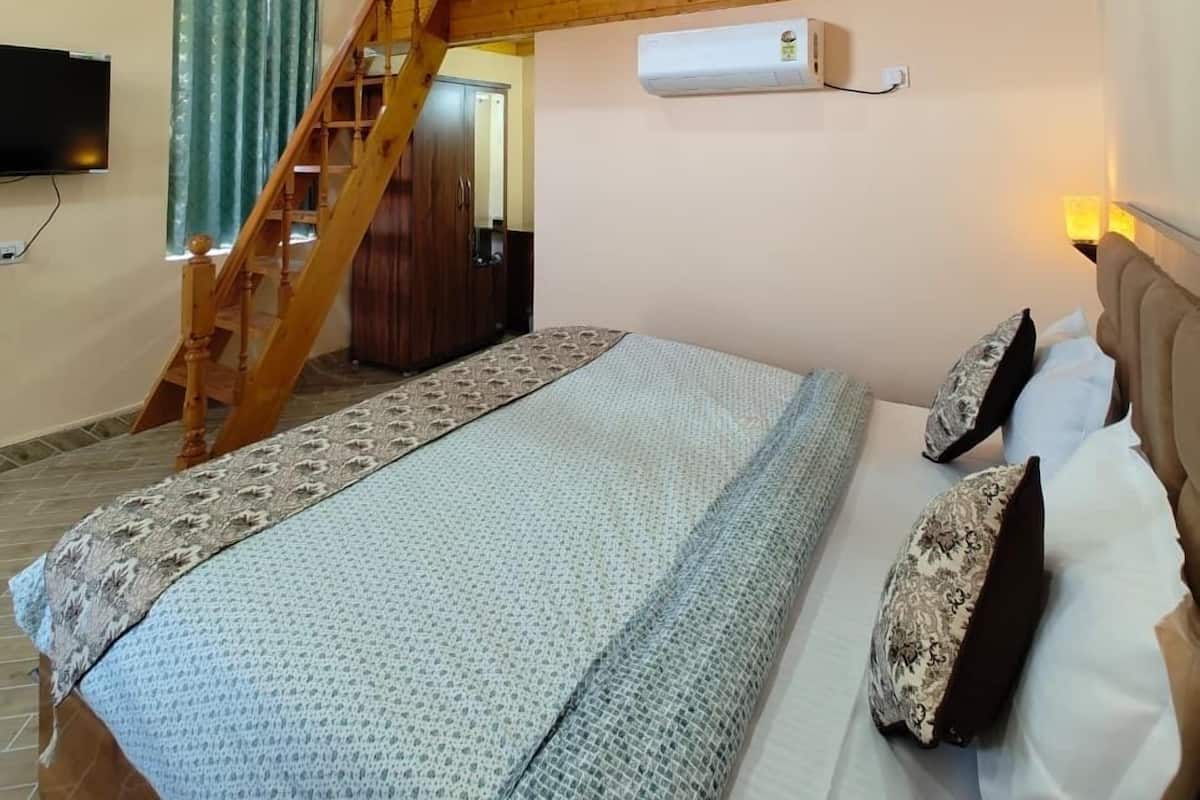 A bedroom with a bunk bed, a wooden staircase, a ceiling fan, and an air conditioning unit.