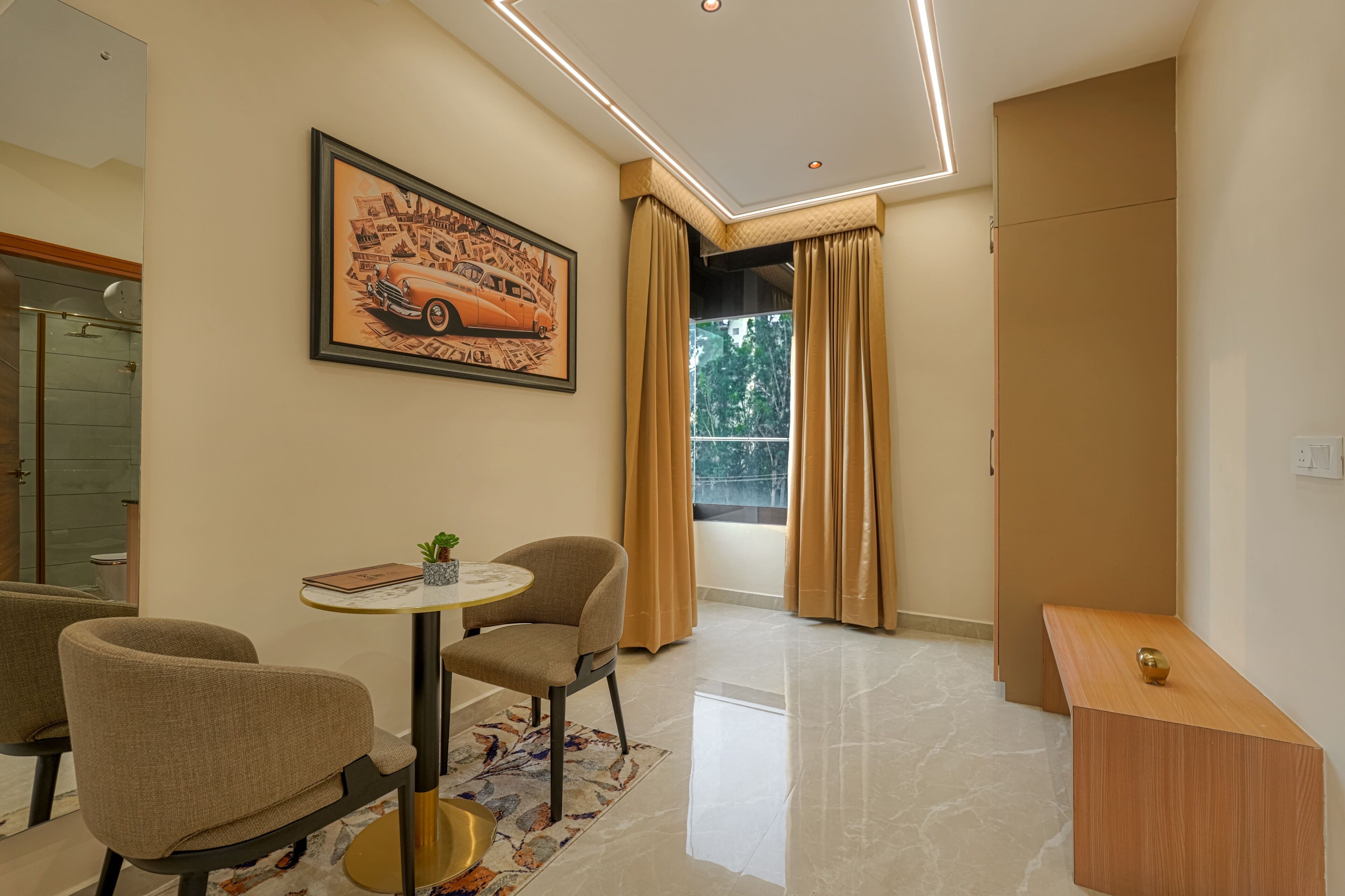 A modern living room with a dining area, a large window with curtains, and a framed picture on the wall.