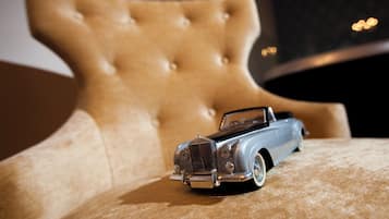 A model car on a tufted chair.