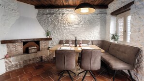 A rustic dining area with a brick fireplace, wooden ceiling beams, and a stone wall. - Casa Lampadina with pool  for 4-6 persons, located near Porec. Pets are welcome. (Vižinada)