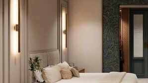 A bedroom with a bed, nightstands, and a decorative wall.