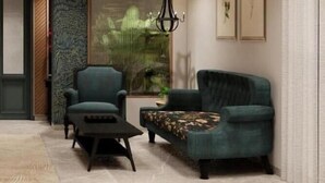 A modern interior with a sofa, armchair, and a small table.