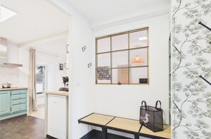 A kitchen with a built-in dishwasher, a coffee machine, and a hanging light fixture. - -TELMA-T2 in the city center - 500 m beach (Concarneau)